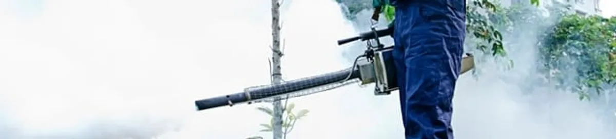 Pest control technician fogging an outdoor area for insect control in Irvine, CA