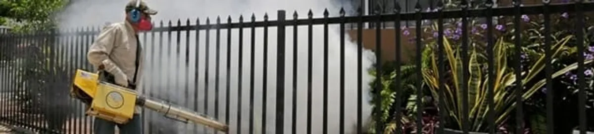 Mosquito control technician fogging a yard perimeter for mosquito reduction in Irvine, CA